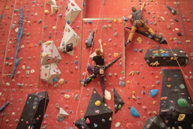 Two children climbing up the red wall at Leisure World Tiptree
