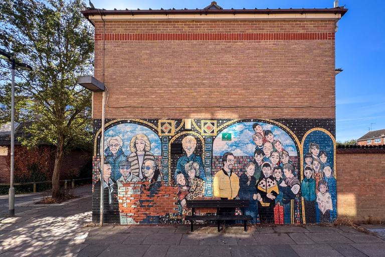 A photo of a mural in Greenstead showing a group of different people on a sunny day