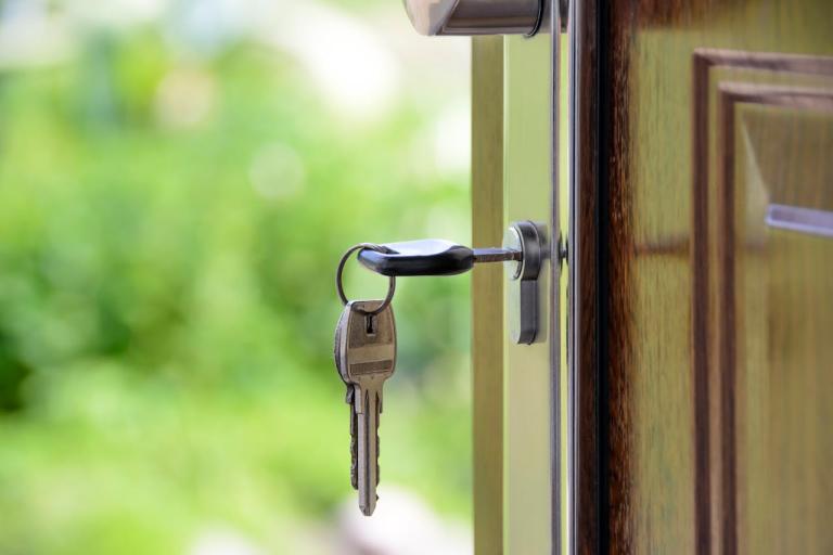 Photo of a key in the front door of a house