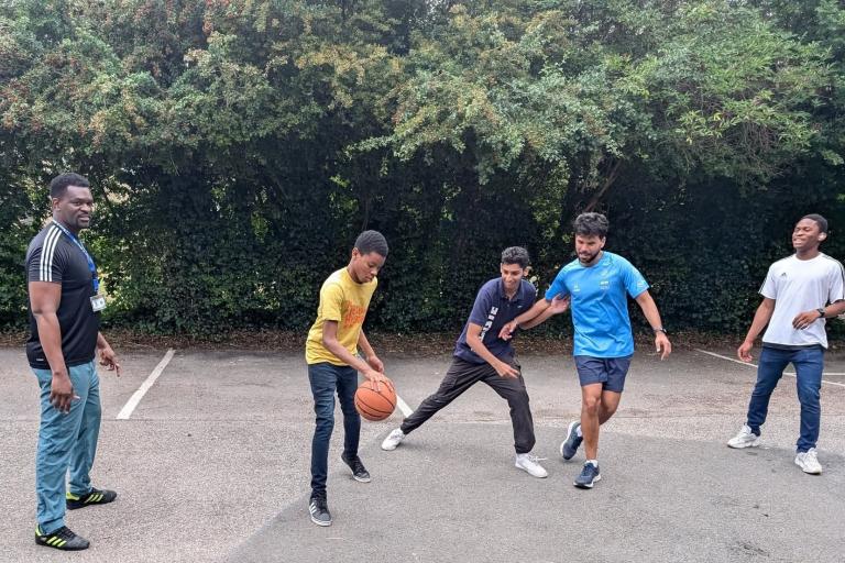 A group of young men playing basketball
