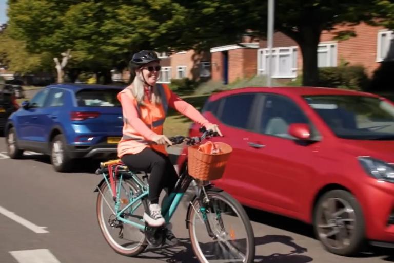  A woman on a bicycle riding in the street