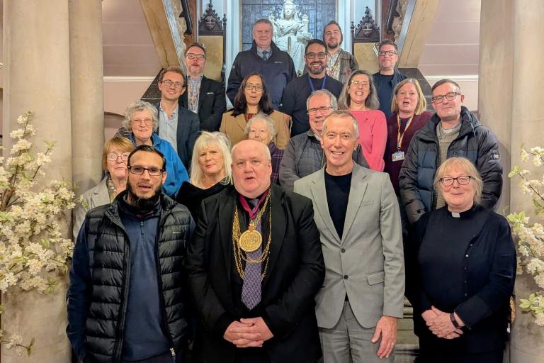 Members of the Mult-Faith Committee pose on the stairwell of Colchester Town Hall
