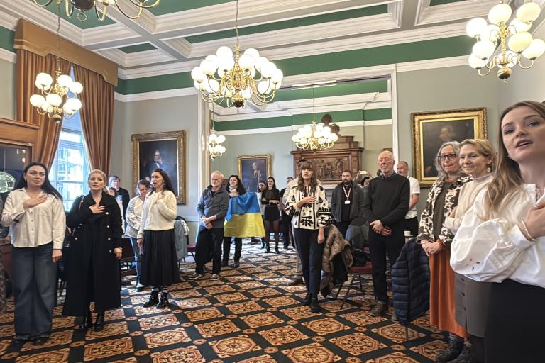 People singing the Ukrainian National Anthem during the event in Colchester Town Hall
