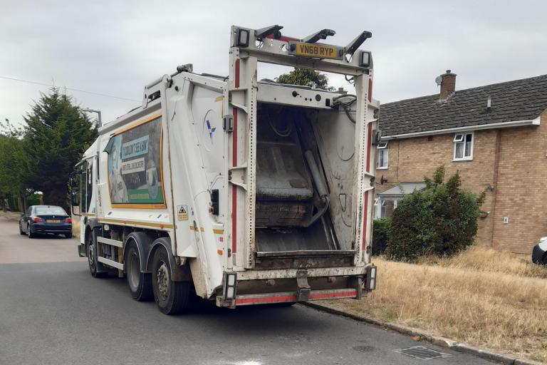 A council waste and recycling vehicle parked in the street