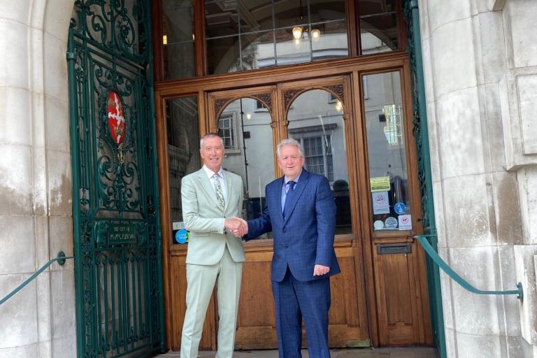 Cllr Paul Dundas, Leader of Colchester City Council, shaking hands outside Colchester Town Hall with Cllr David Kind, Deputy Leader of Colchester City Council
