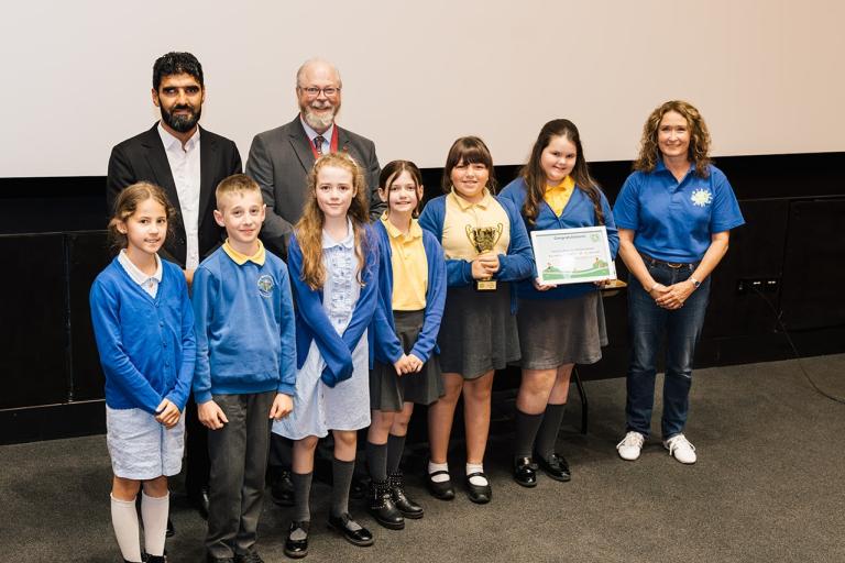 Overall Winners of Beat the Street Colchester 2026, Kendall Primary School photographed with Athelte, Wali Noori; Mayor of Colchester, Andrew Ellis and Director of Intelligent Health, Katherine Knight. 