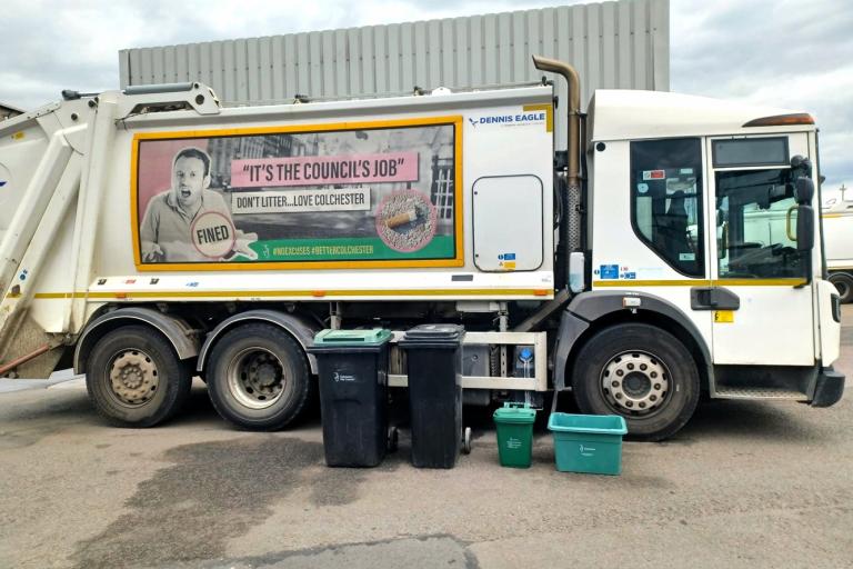 A waste and recycling lorry with wheelie bins and other containers in the foreground