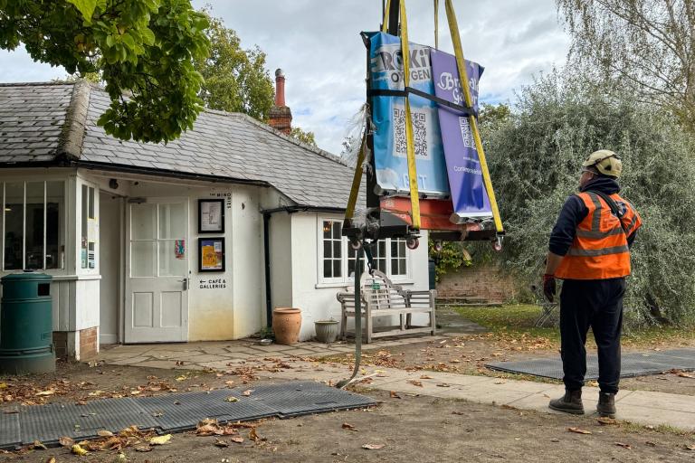 A Banksy artwork is lowered by crane at the rear of The Minories Gallery