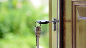 Photo of a key in the front door of a house