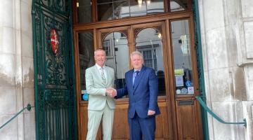 Cllr Paul Dundas, Leader of Colchester City Council, shaking hands outside Colchester Town Hall with Cllr David Kind, Deputy Leader of Colchester City Council