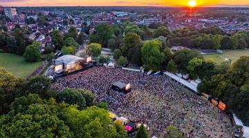 An aerial view of an open air concert in Lower Castle Park