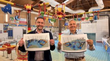 Cllr Goss and Cllr Sunnucks holding plans for new water features at the Leisure Pool