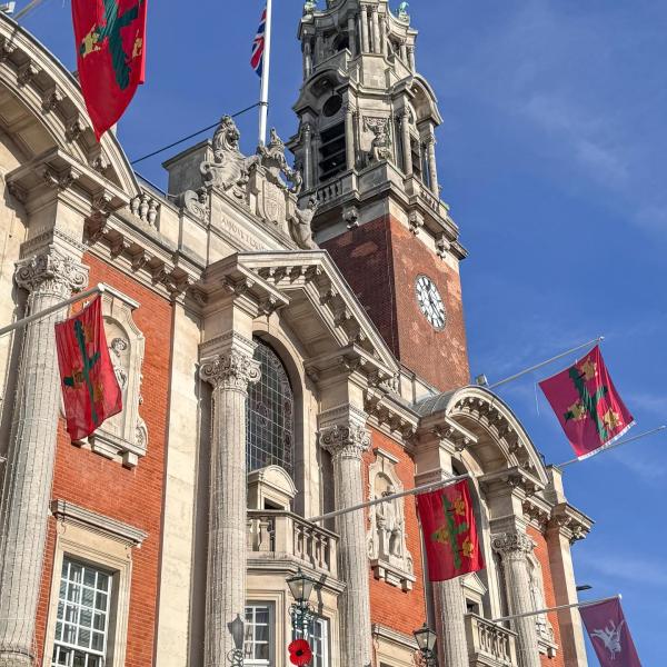 Photo of Colchester Town Hall decorated with red flags for Remembrance Sunday