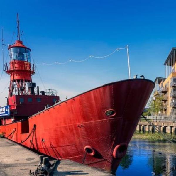 Red boat docked at the quay in Hythe Colchester on a sunny day