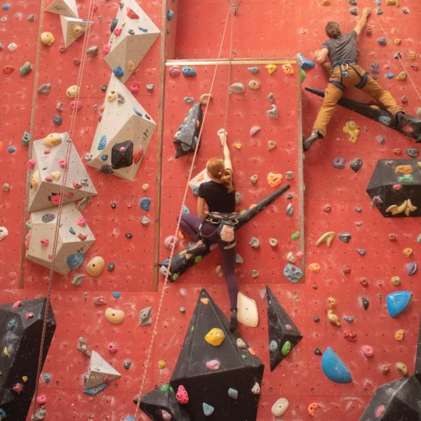 Two children climbing up the red wall at Leisure World Tiptree