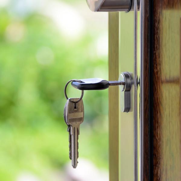 Photo of a key in the front door of a house