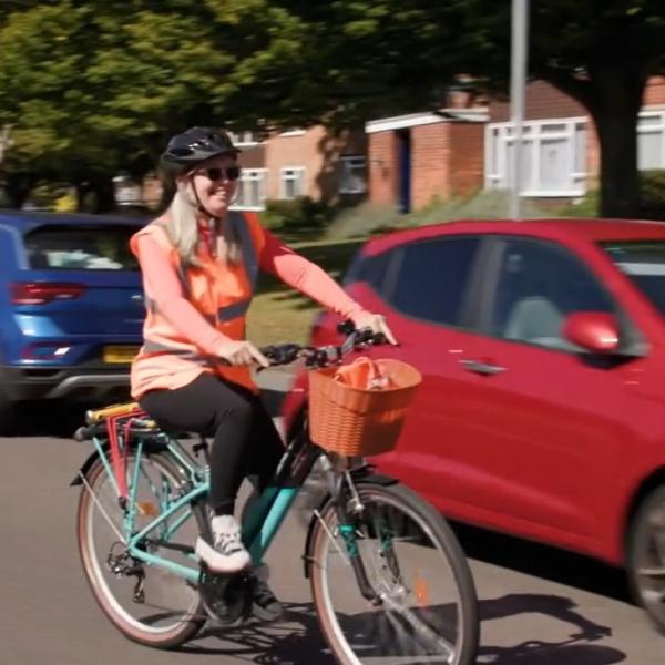  A woman on a bicycle riding in the street