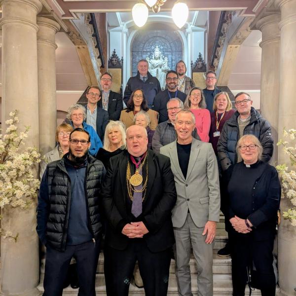 Members of the Mult-Faith Committee pose on the stairwell of Colchester Town Hall