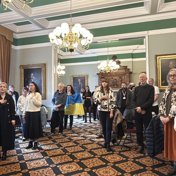 People singing the Ukrainian National Anthem during the event in Colchester Town Hall