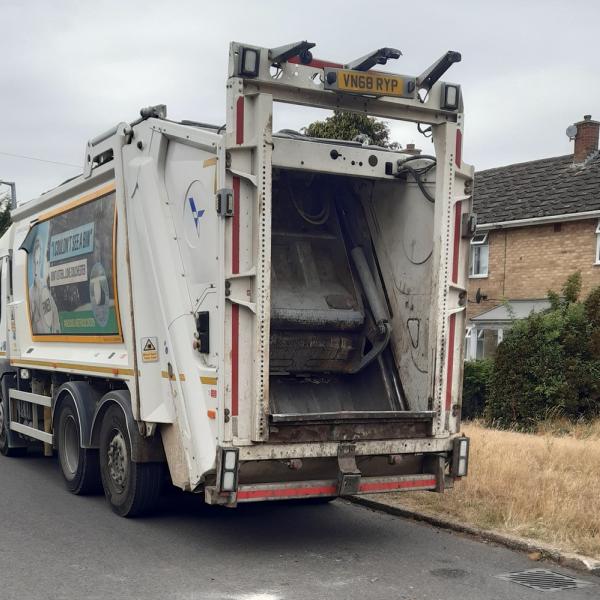 A council waste and recycling vehicle parked in the street