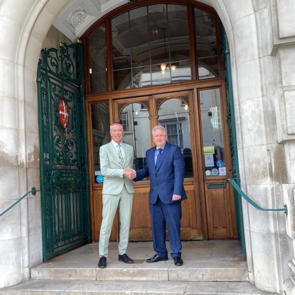 Cllr Paul Dundas, Leader of Colchester City Council, shaking hands outside Colchester Town Hall with Cllr David Kind, Deputy Leader of Colchester City Council
