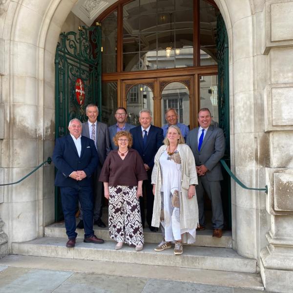 Colchester City Council Cabinet Members standing on the steps of Colchester Town Hall - all smiling