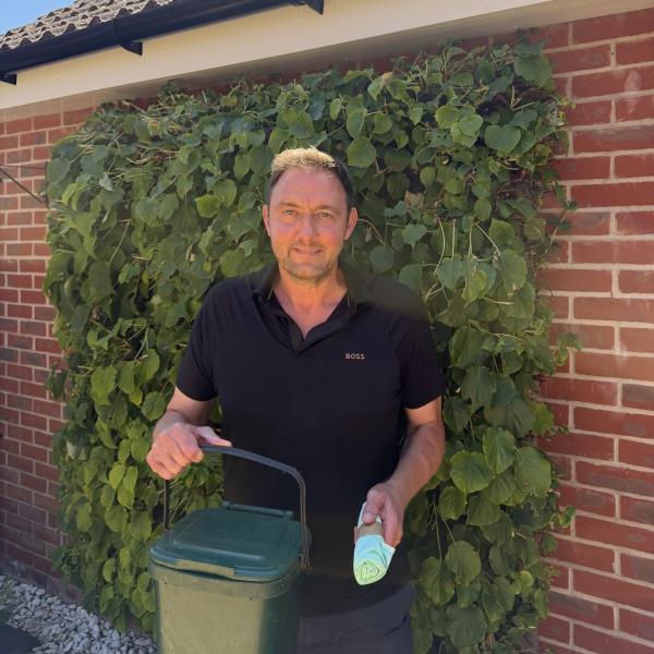 Cllr Martin Goss holding a food caddy