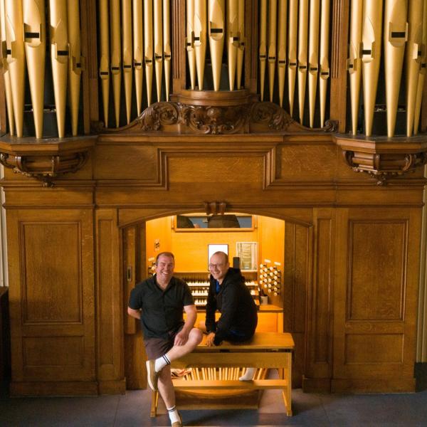 Cllr Darius Laws and City Organist William Saunders seated side by side at the Moot Hall Organ