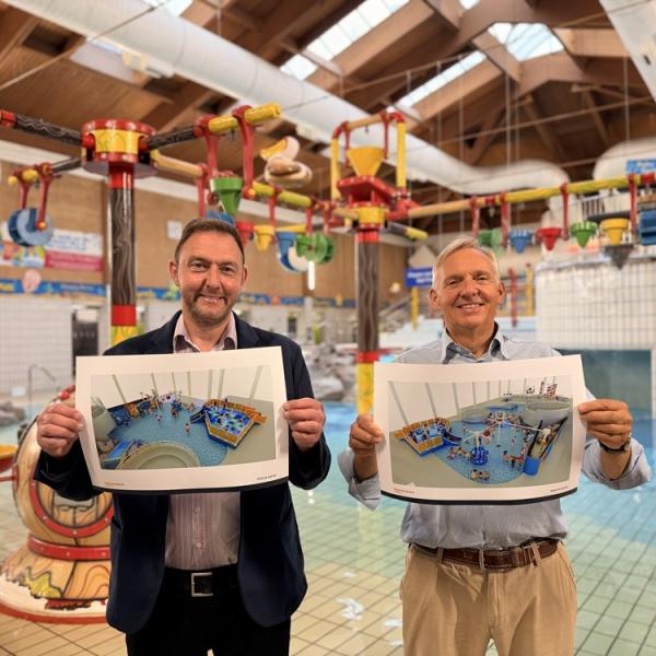 Cllr Goss and Cllr Sunnucks holding plans for new water features at the Leisure Pool