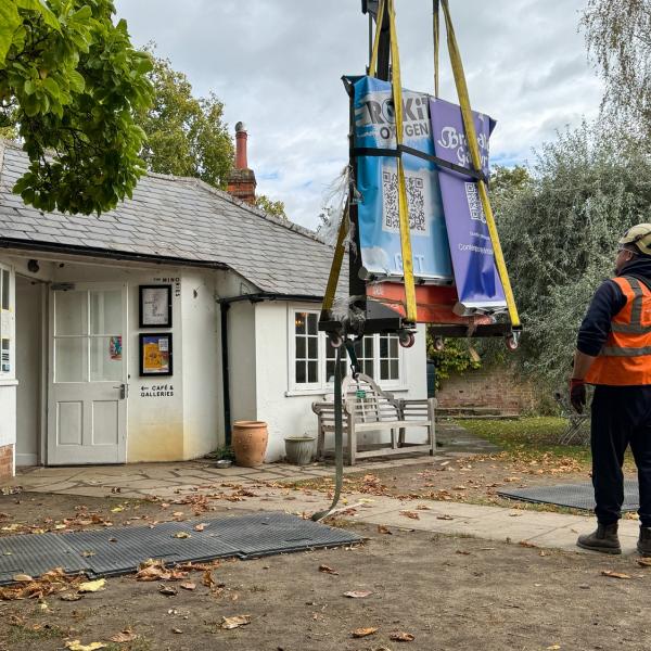 A Banksy artwork is lowered by crane at the rear of The Minories Gallery
